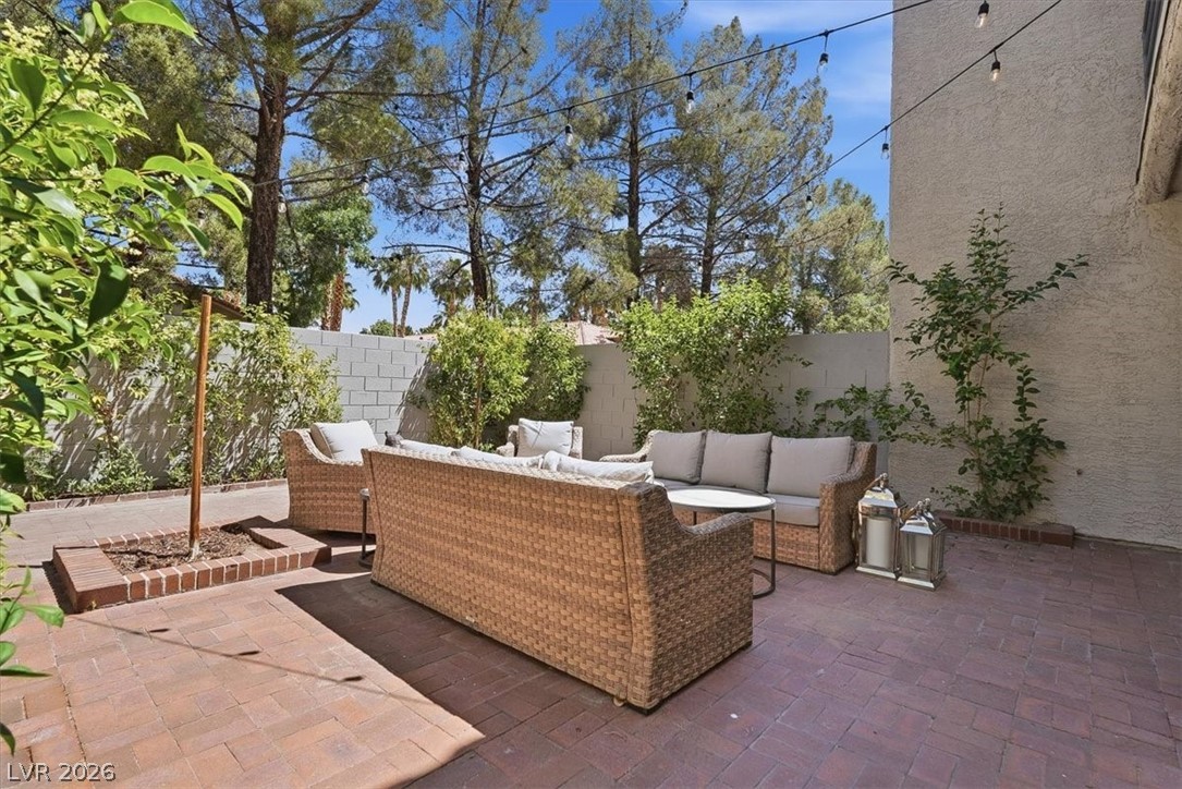 6250 West Flamingo Road, Unit 93 Las Vegas, NV 89103 - Photo 20 of 38 An inviting patio featuring pavers and lush greenery creates an ideal outdoor retreat.
