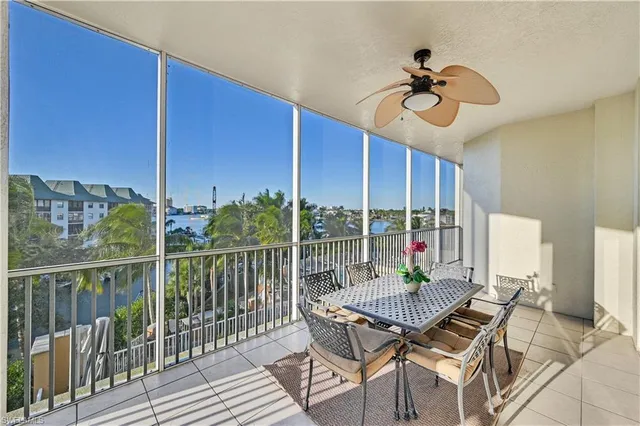 a view of a balcony dining table and chairs