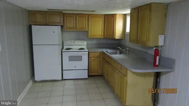 a kitchen with a sink a stove and cabinets