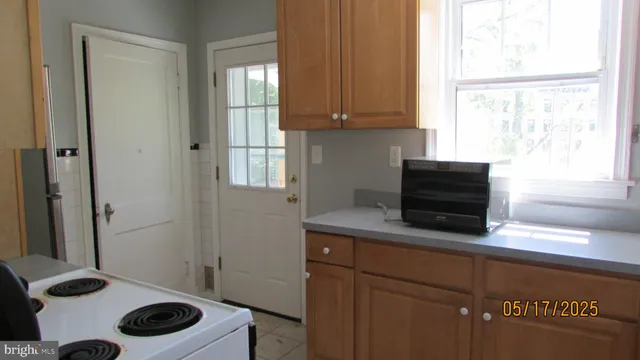 a kitchen with a cabinets and window