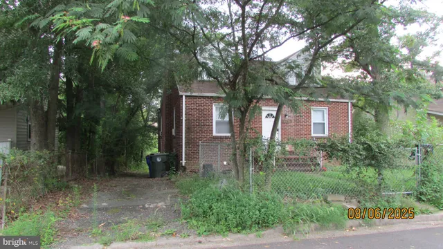a brick house with trees in front of it