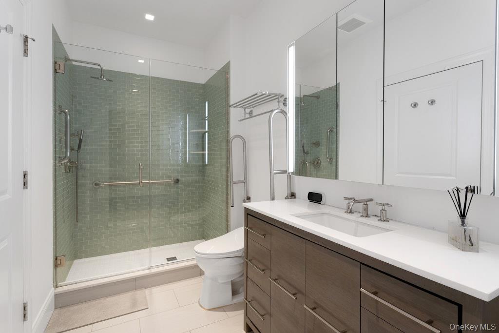 18 Rivers Edge Drive, Unit 211 Tarrytown, NY 10591 - Photo 14 of 30 a bathroom with a sink a toilet and shower