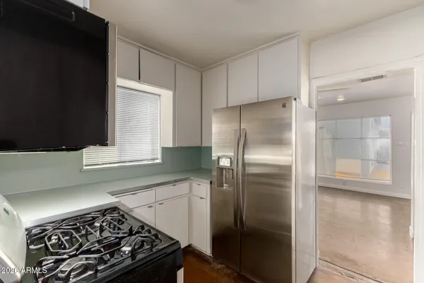 a kitchen with a stove and a refrigerator