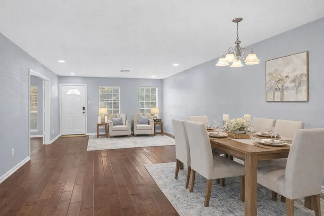 a view of a dining room with furniture wooden floor and chandelier