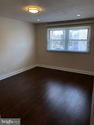 a view of room with window and wooden floor