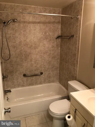 a bathroom with a toilet and a bath tub