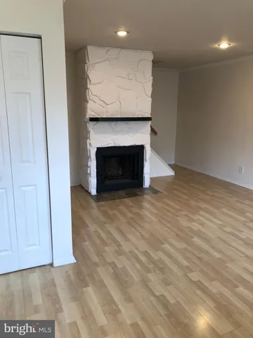 a view of an empty room with a fireplace
