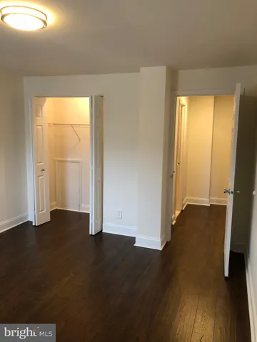 a view of a room with wooden floor and a window