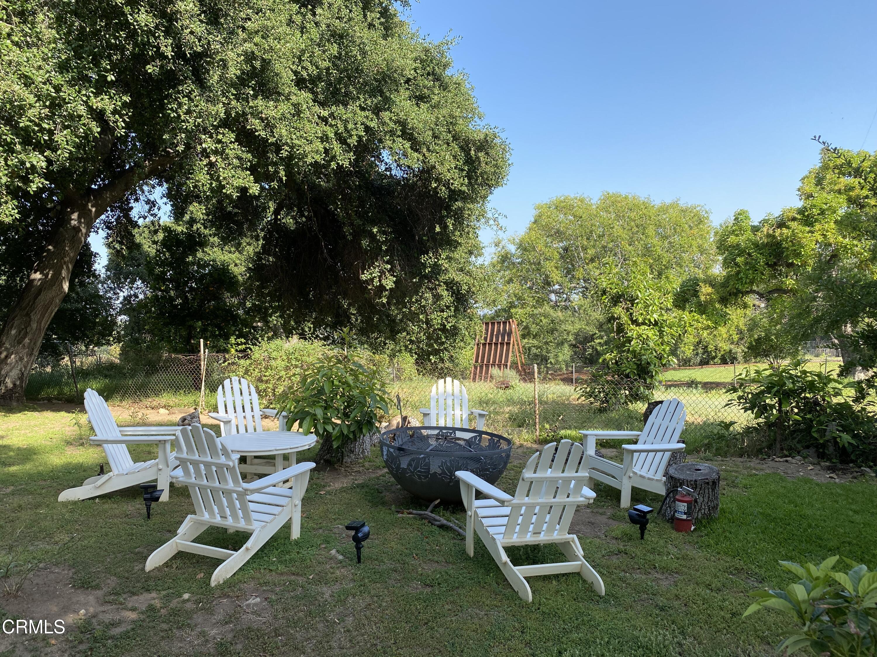 a view of a chairs and table in a yard
