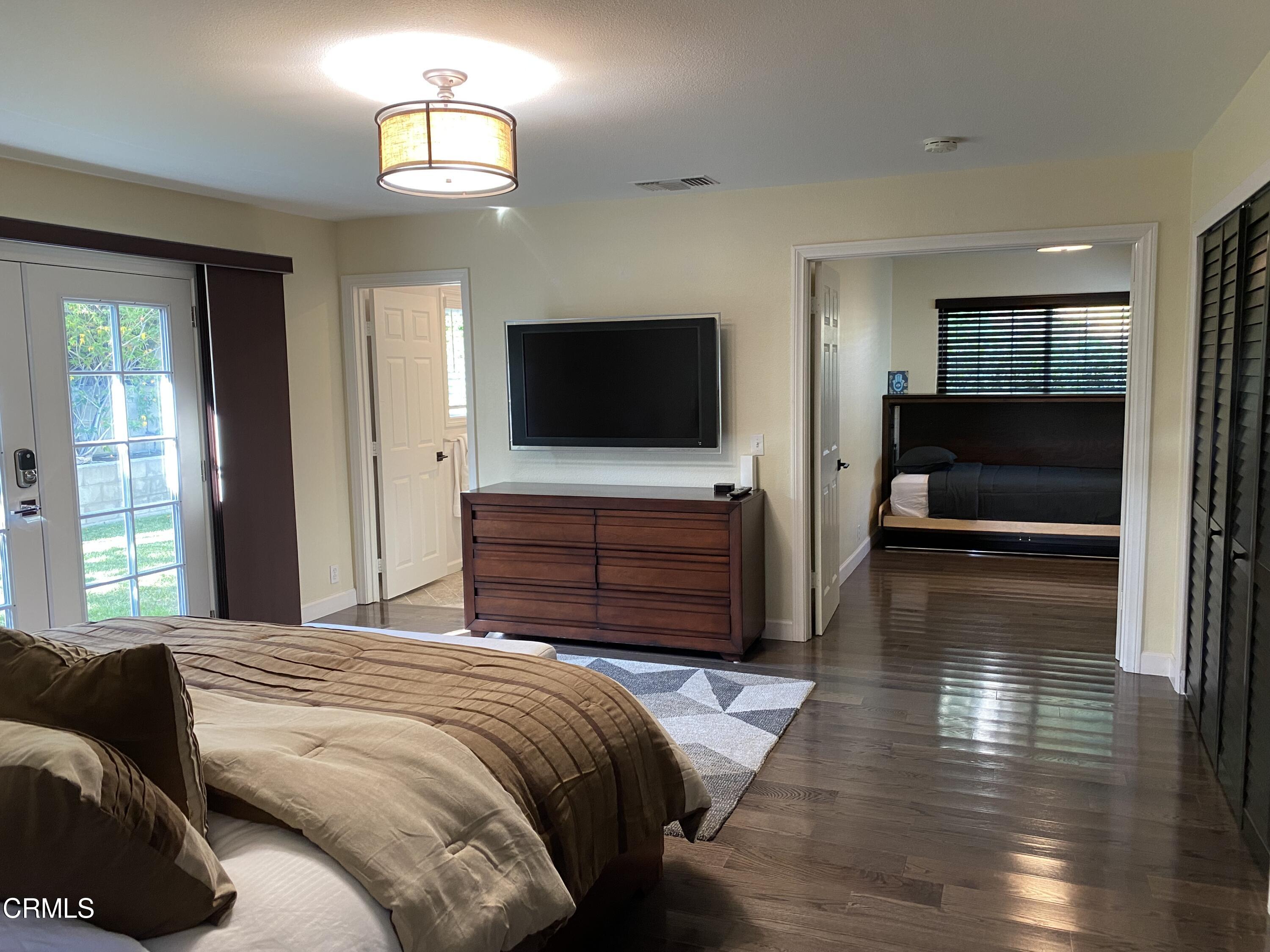 378 Grand Avenue Monrovia, CA 91016 - Photo 5 of 18 a bedroom with a bed and a flat screen tv