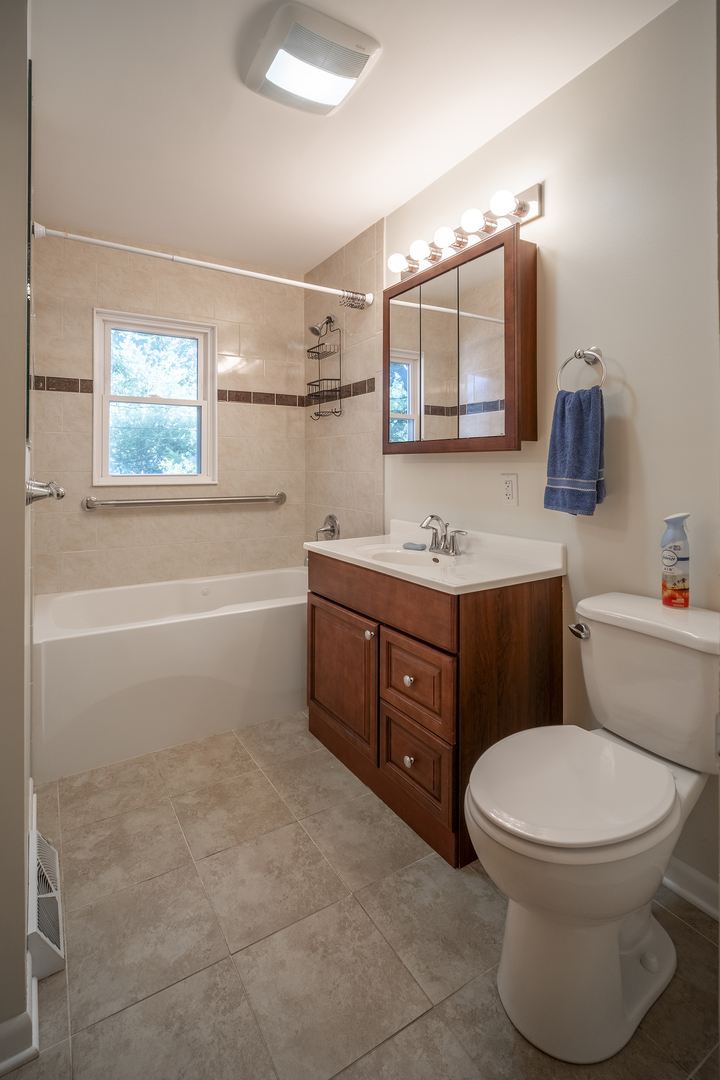47 Briarcliff Road Montgomery, IL 60538 - Photo 12 of 19 a bathroom with a toilet a sink a mirror and vanity