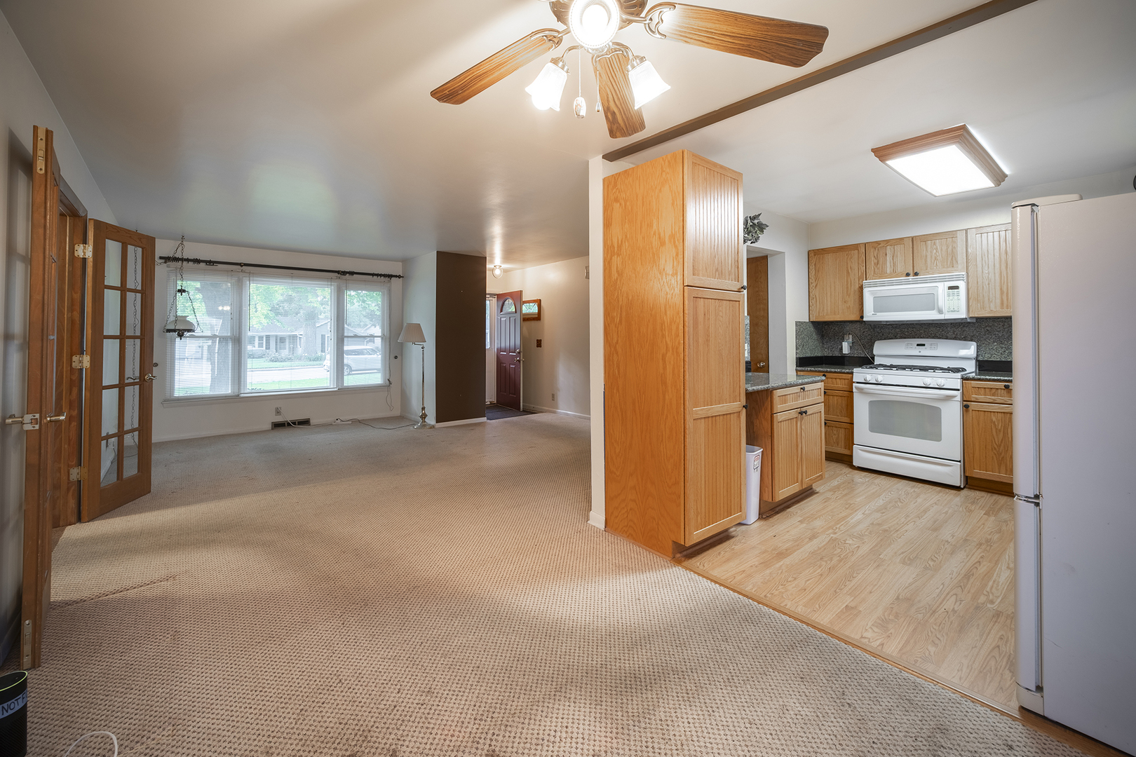 47 Briarcliff Road Montgomery, IL 60538 - Photo 4 of 19 a open kitchen with stainless steel appliances granite countertop a refrigerator a stove and a sink with wooden floor