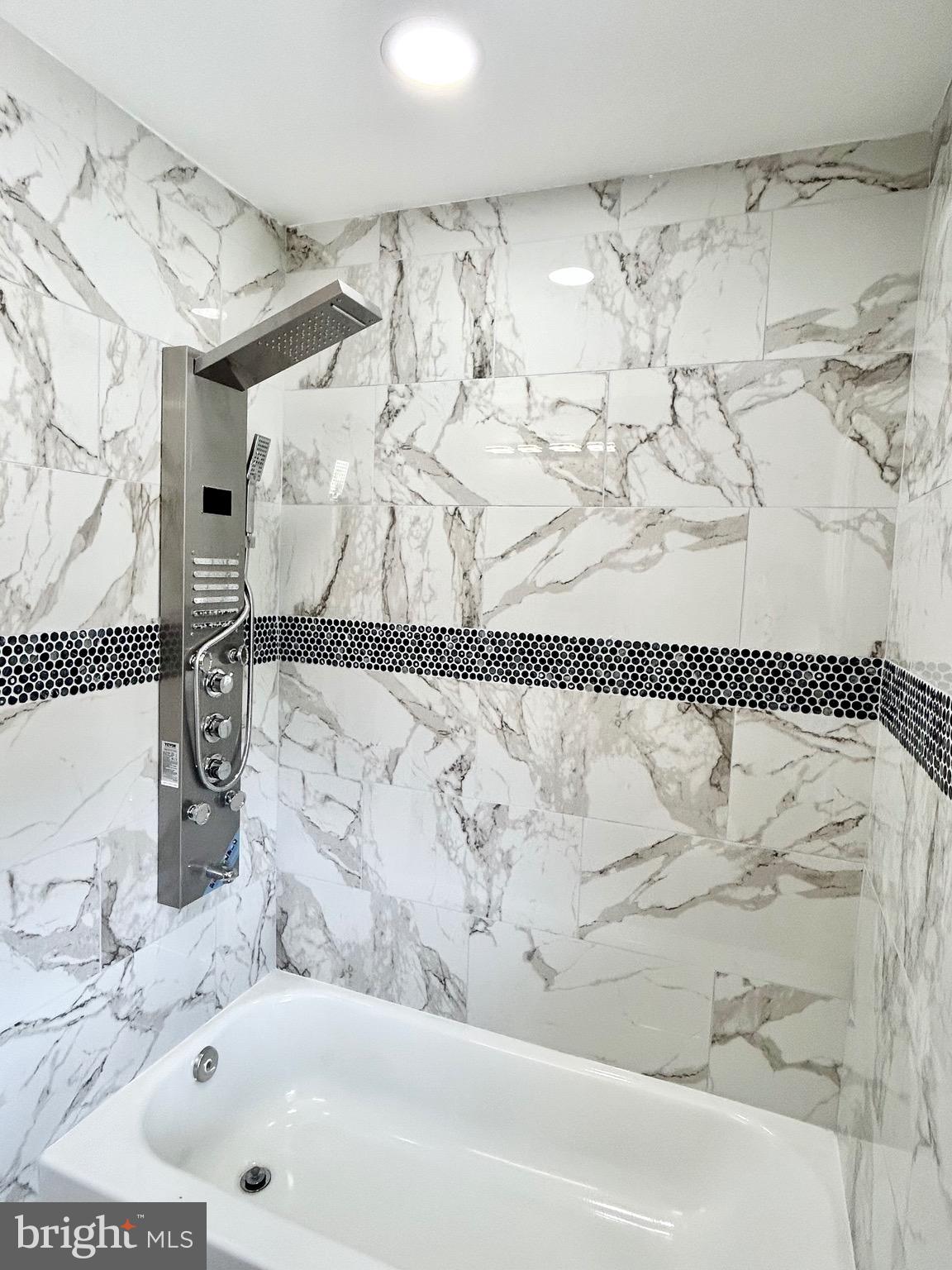 3506 Elmora Avenue Baltimore, MD 21213 - Photo 15 of 27 a bathroom with a bathtub and a shower