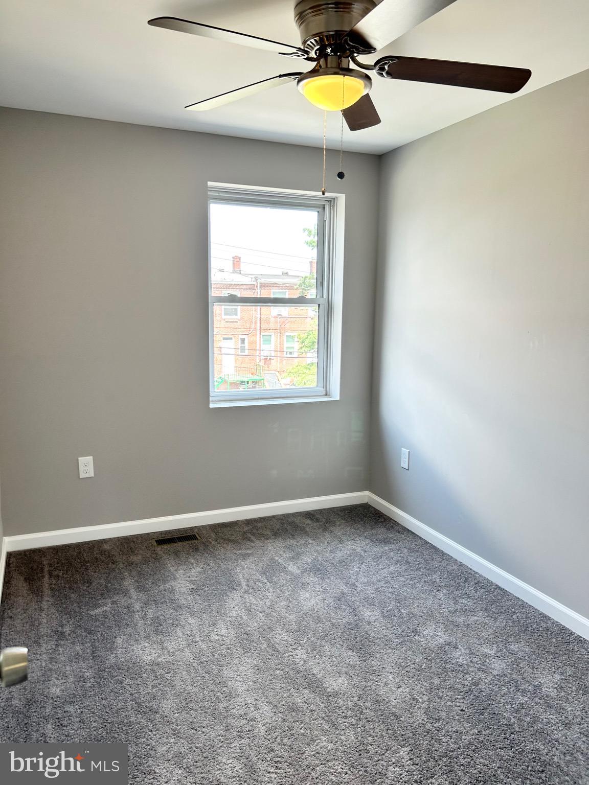 3506 Elmora Avenue Baltimore, MD 21213 - Photo 18 of 27 an empty room with windows and chandelier