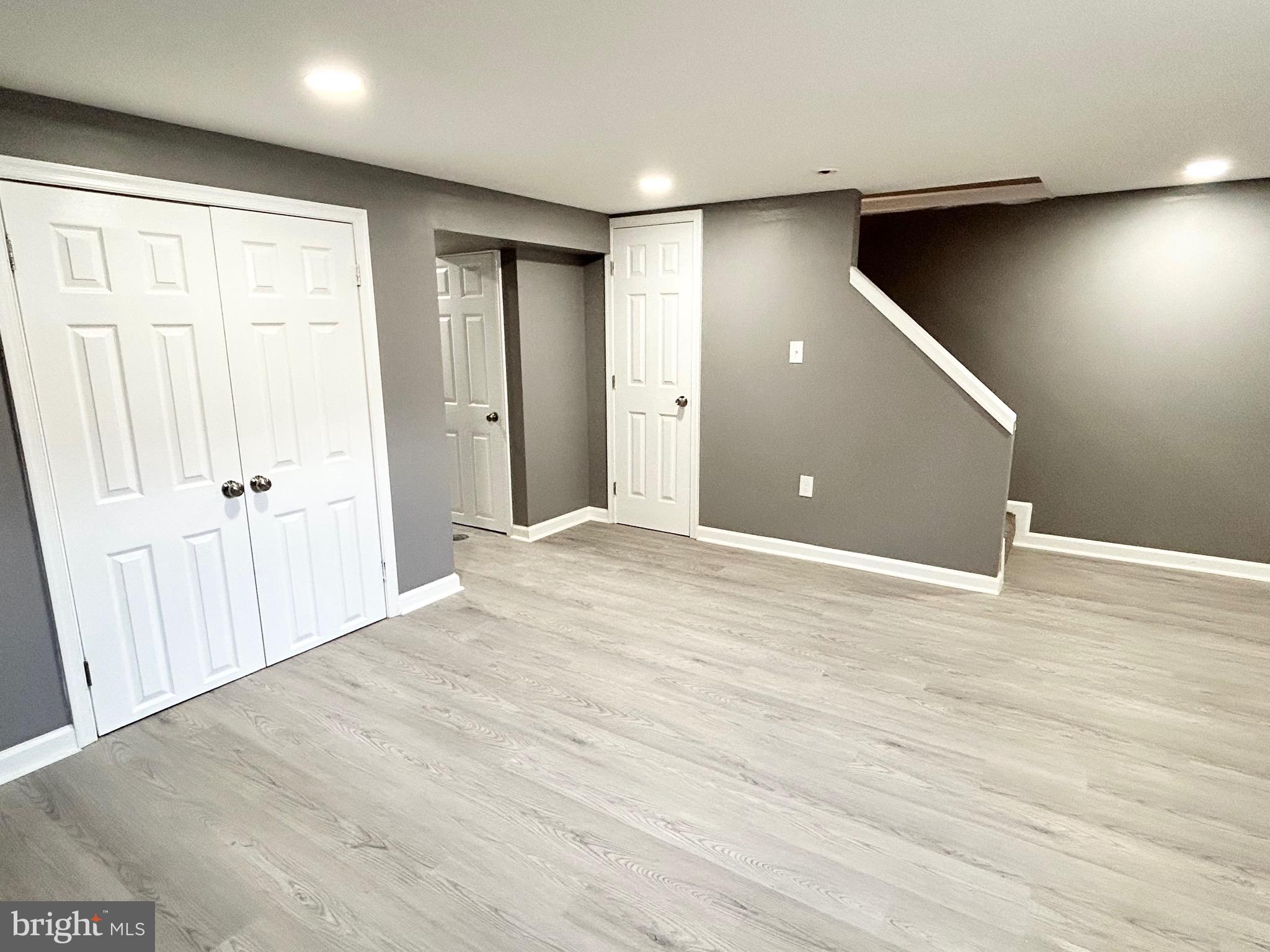 3506 Elmora Avenue Baltimore, MD 21213 - Photo 20 of 27 a view of an empty room with wooden floor