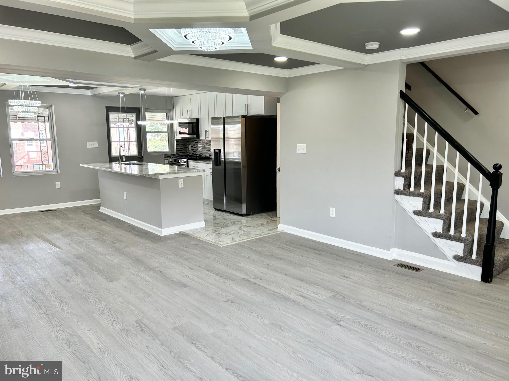 3506 Elmora Avenue Baltimore, MD 21213 - Photo 3 of 27 a view of a hallway with wooden floor and staircase