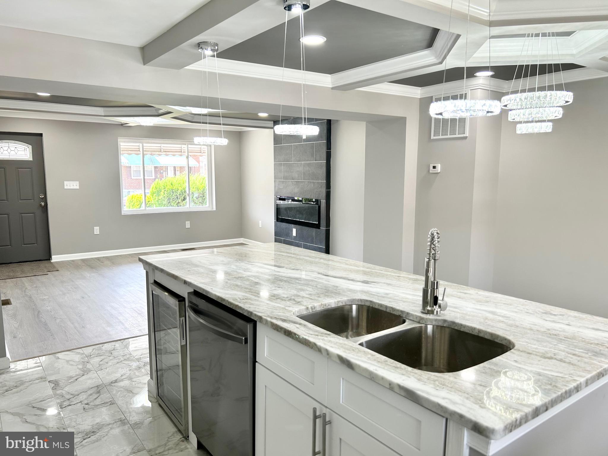 3506 Elmora Avenue Baltimore, MD 21213 - Photo 10 of 27 a kitchen with a sink a refrigerator and window