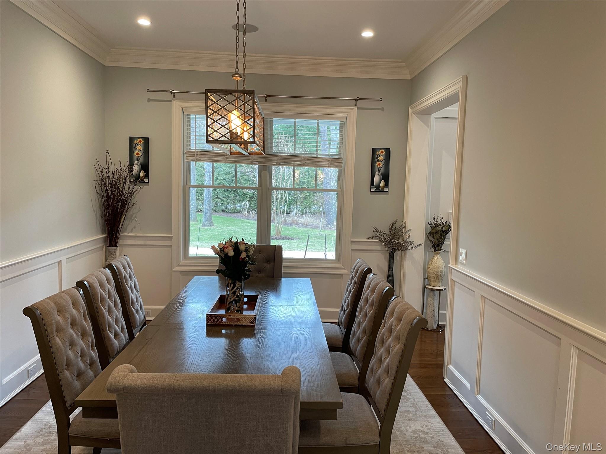 99 Spinney Road East Quogue, NY 11942 - Photo 11 of 40 a living room with furniture chandelier and a window