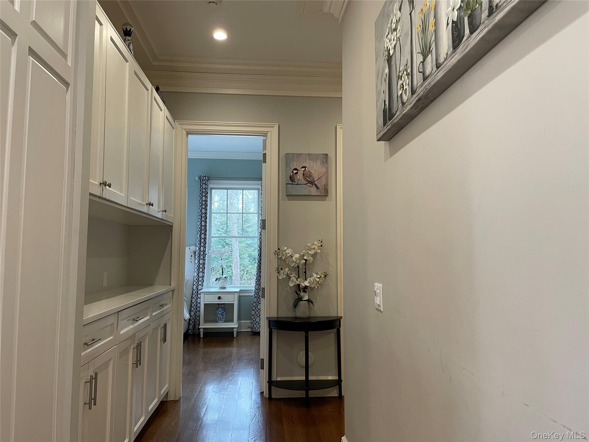 99 Spinney Road East Quogue, NY 11942 - Photo 13 of 40 a view of a hallway with wooden floor and staircase