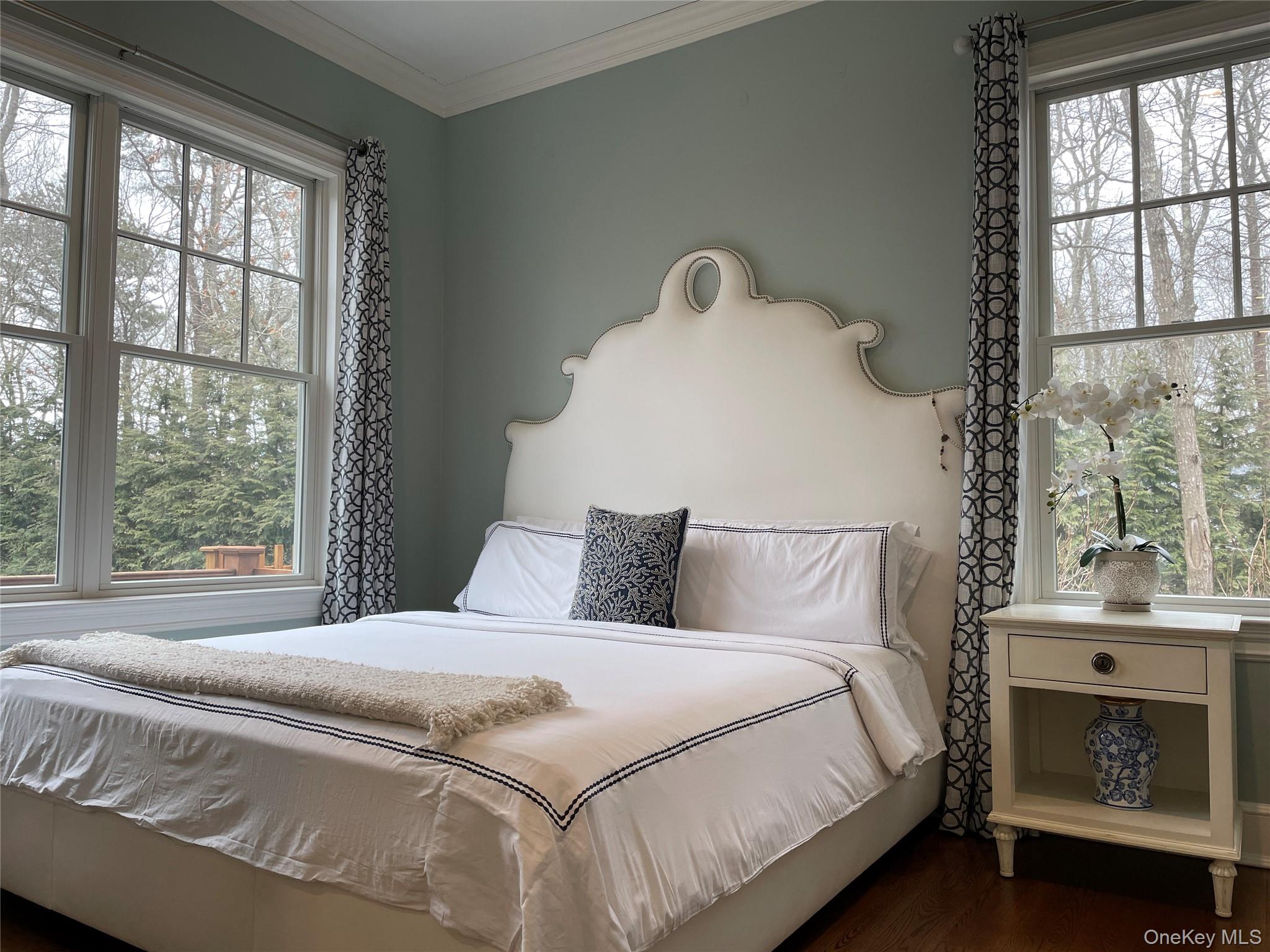99 Spinney Road East Quogue, NY 11942 - Photo 15 of 40 a bedroom with a bed and a window
