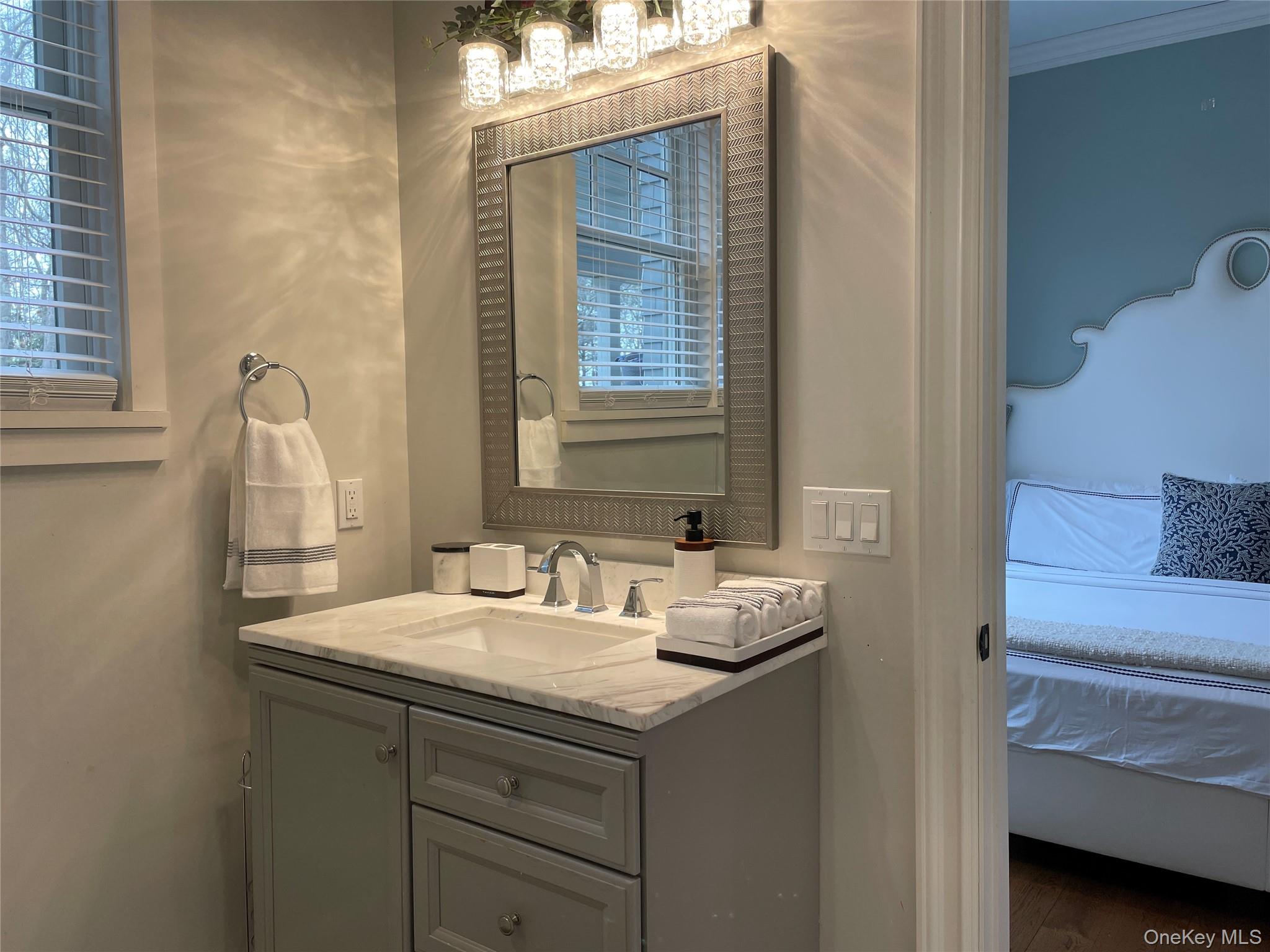 99 Spinney Road East Quogue, NY 11942 - Photo 16 of 40 a bathroom with a sink and a mirror