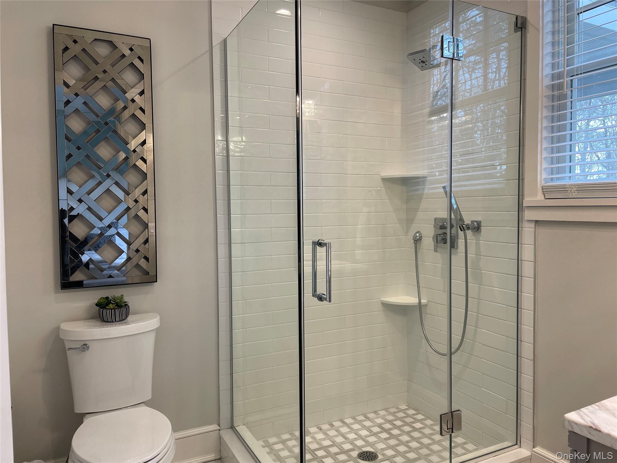 99 Spinney Road East Quogue, NY 11942 - Photo 17 of 40 a bathroom with a toilet and shower