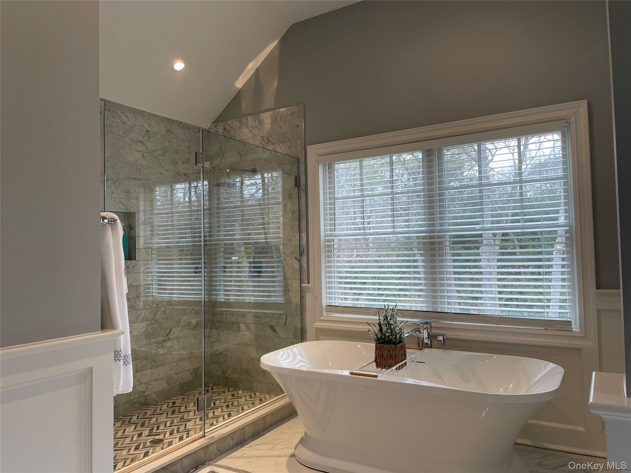 99 Spinney Road East Quogue, NY 11942 - Photo 20 of 40 a bathroom with a bathtub and shower