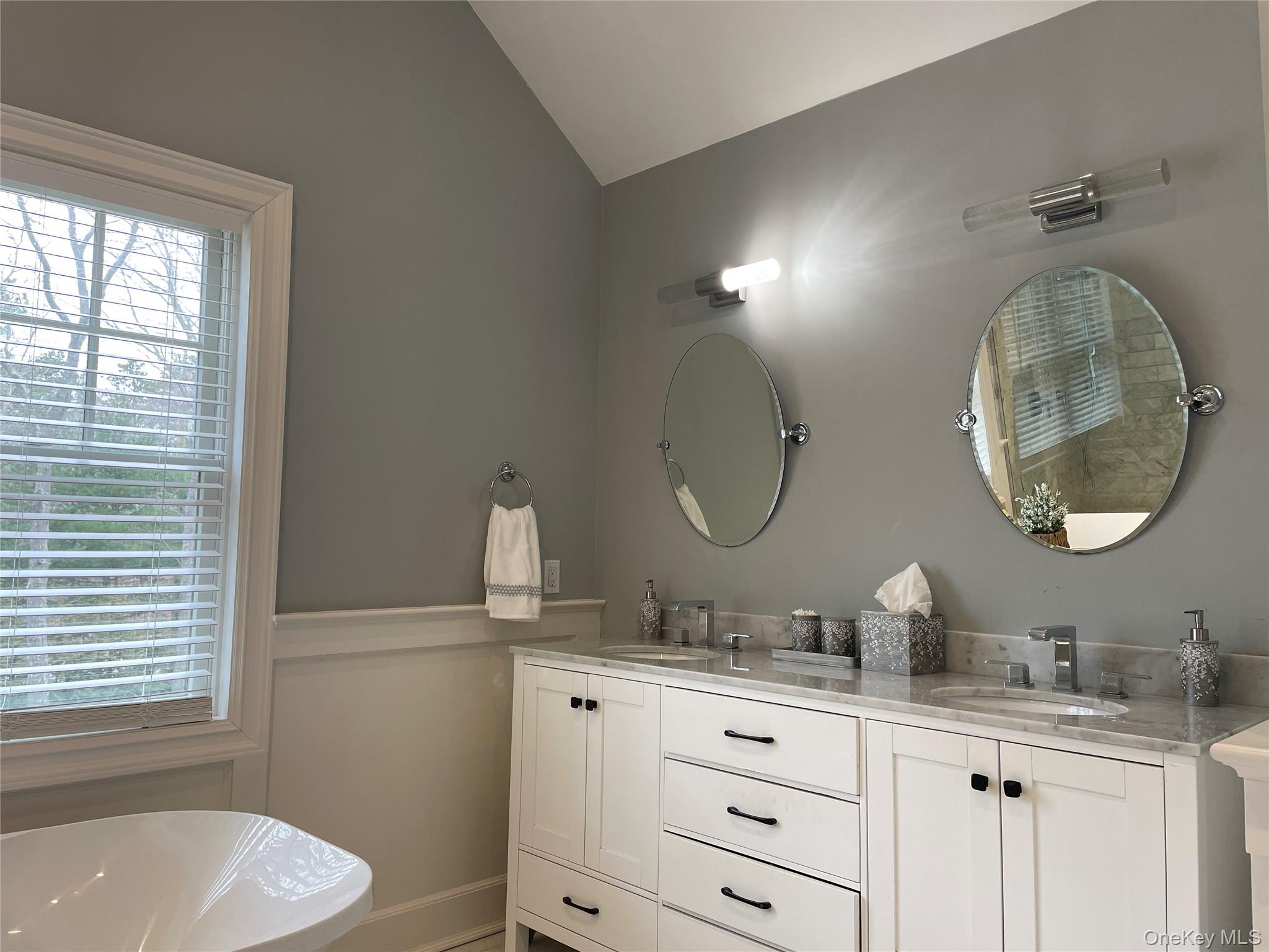 99 Spinney Road East Quogue, NY 11942 - Photo 21 of 40 a bathroom with a granite countertop toilet a sink and a mirror