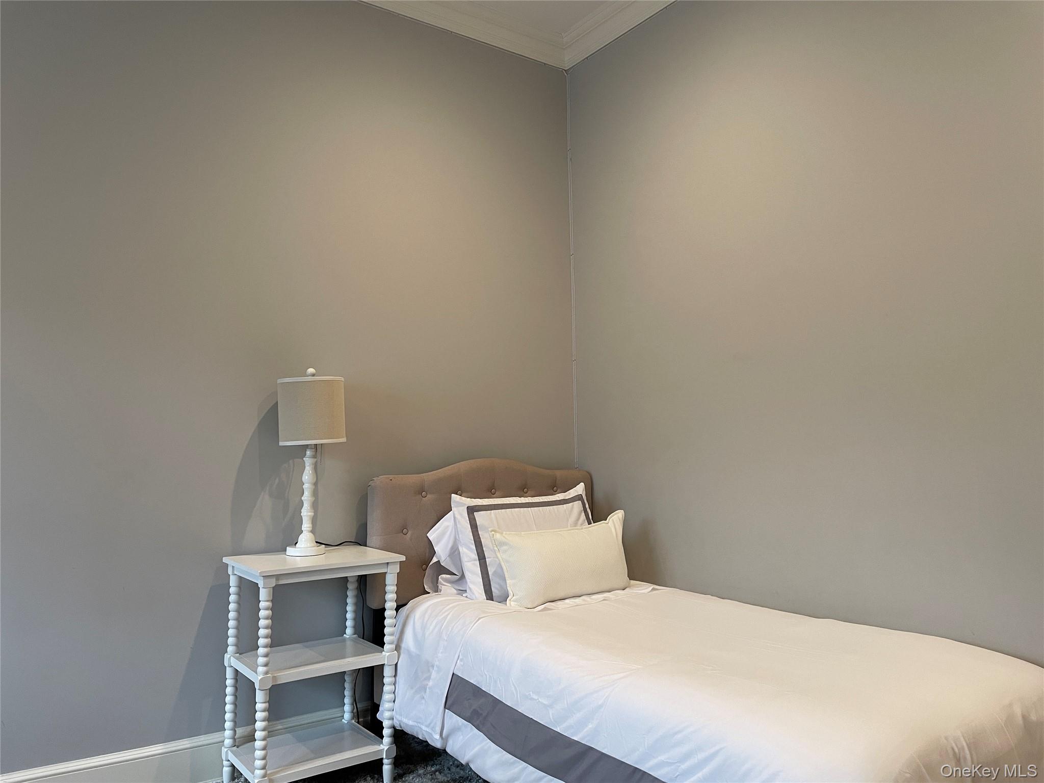 99 Spinney Road East Quogue, NY 11942 - Photo 27 of 40 a bedroom with a bed and chair