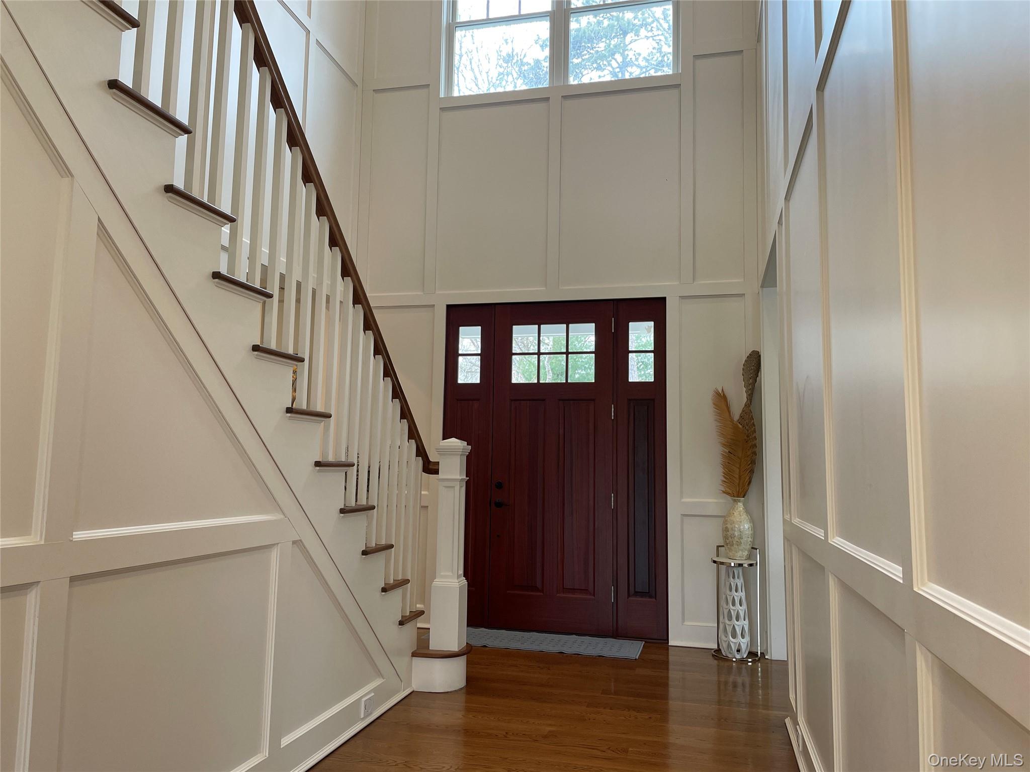 99 Spinney Road East Quogue, NY 11942 - Photo 3 of 40 a view of front door with hallway and wooden floor