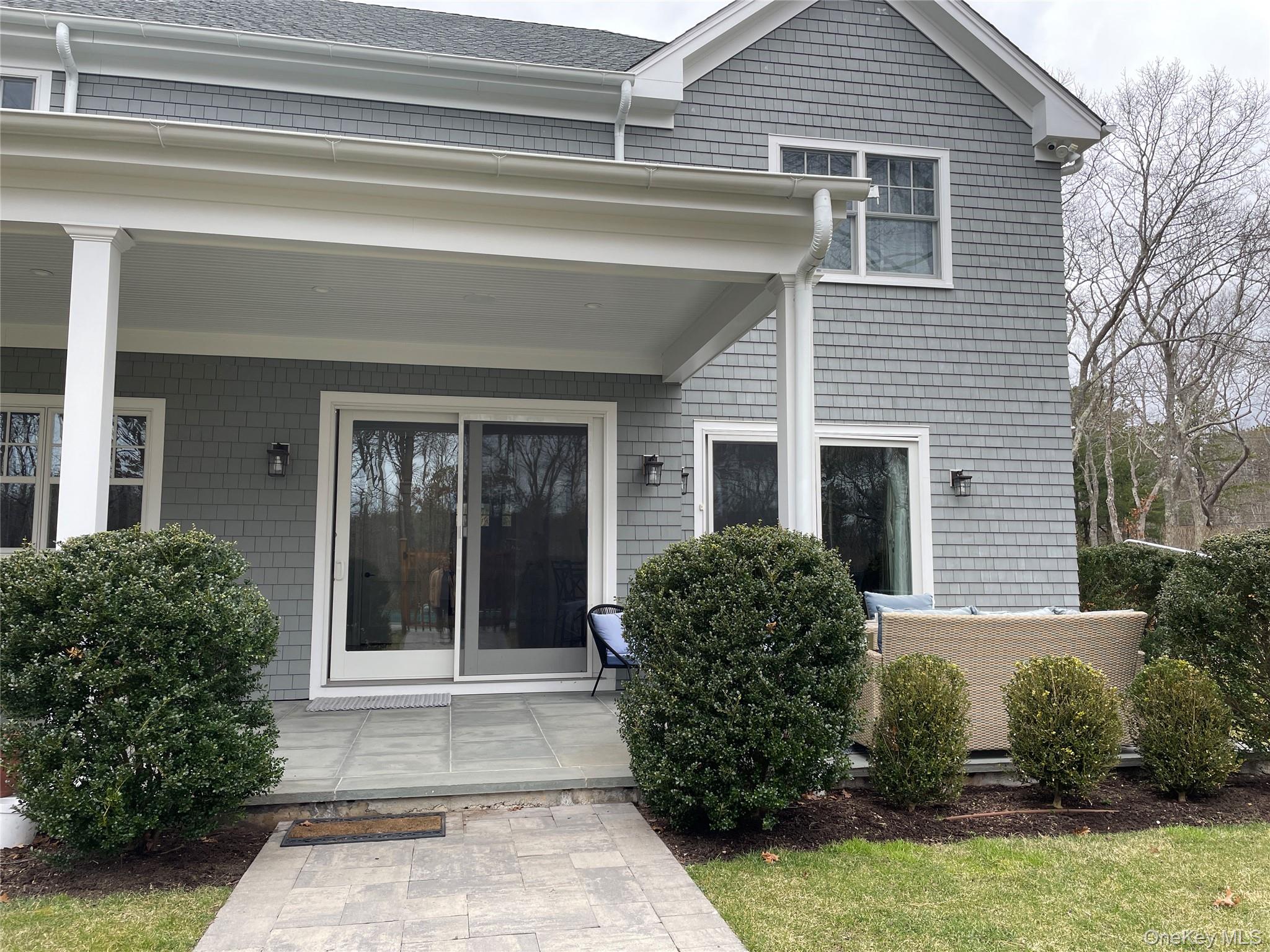 99 Spinney Road East Quogue, NY 11942 - Photo 36 of 40 a view of a house with potted plants