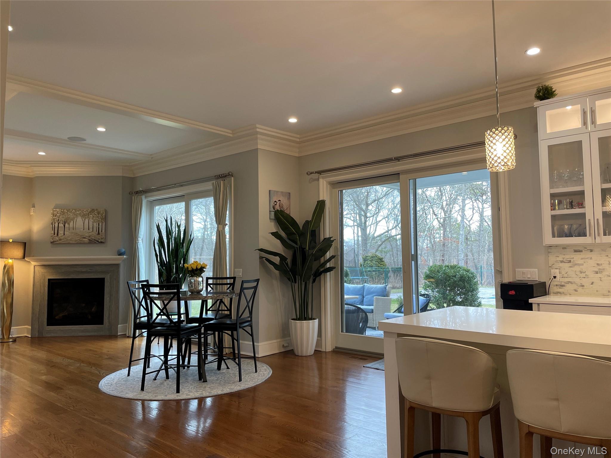 99 Spinney Road East Quogue, NY 11942 - Photo 7 of 40 a dining room with furniture window and wooden floor