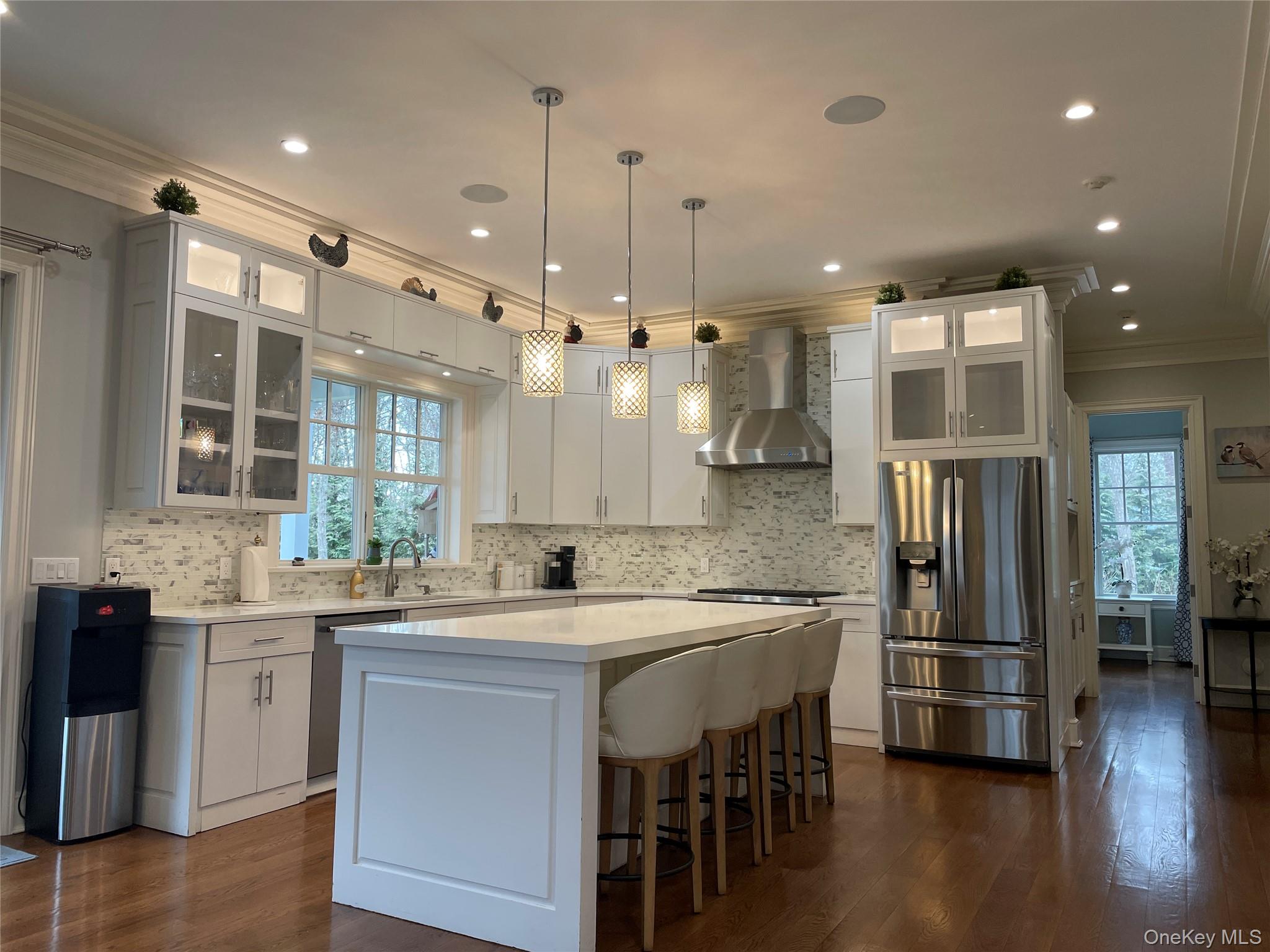 99 Spinney Road East Quogue, NY 11942 - Photo 9 of 40 a kitchen with a sink stove and refrigerator