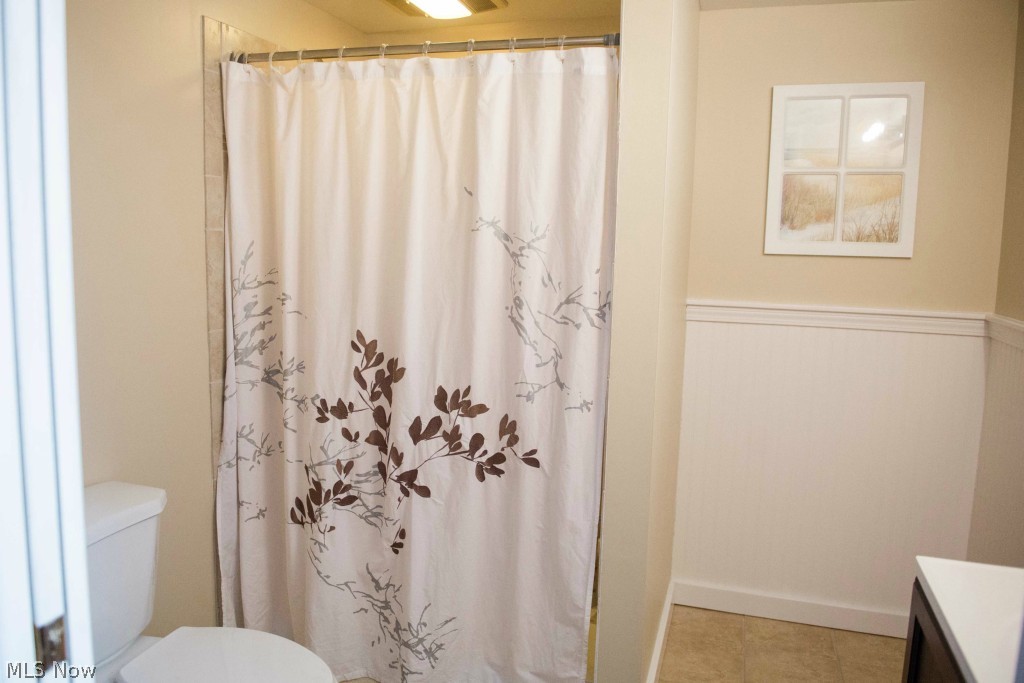 1267 Roland Road Lyndhurst, OH 44124 - Photo 22 of 24 This full bath is located in the fully finished basement. Ceramic tile and wainscot highlight this beautiful space.