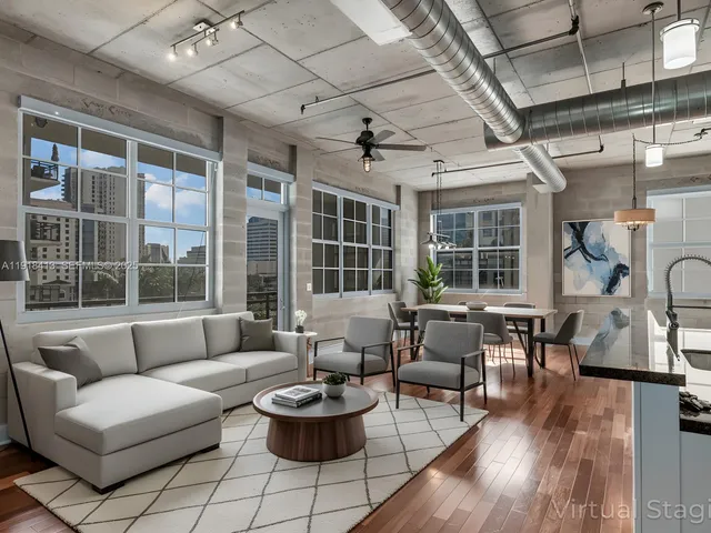 a view of a room with stainless steel appliances granite countertop lots of wooden cabinets