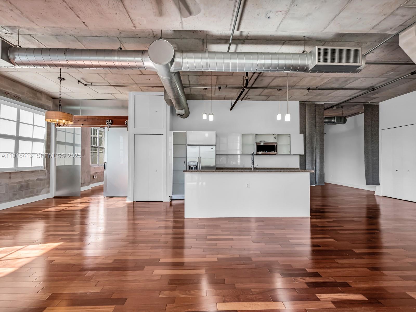 411 Northwest 1st Avenue, Unit 401 Fort Lauderdale, FL 33301 - Photo 13 of 53 a view of a room with stainless steel appliances granite countertop lots of wooden cabinets