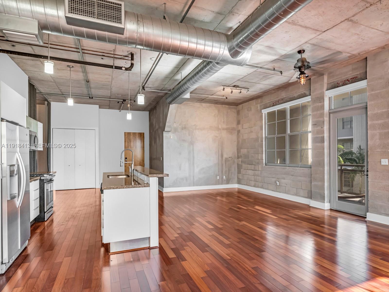 411 Northwest 1st Avenue, Unit 401 Fort Lauderdale, FL 33301 - Photo 14 of 53 a view of a livingroom with wooden floor