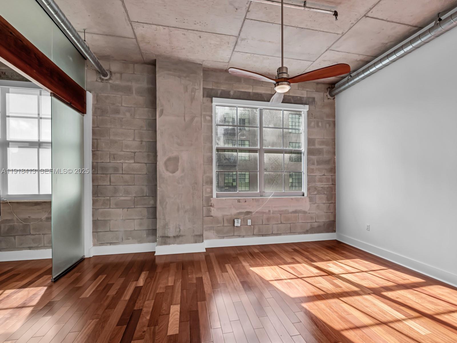 411 Northwest 1st Avenue, Unit 401 Fort Lauderdale, FL 33301 - Photo 22 of 53 a view of empty room with wooden floor and fan