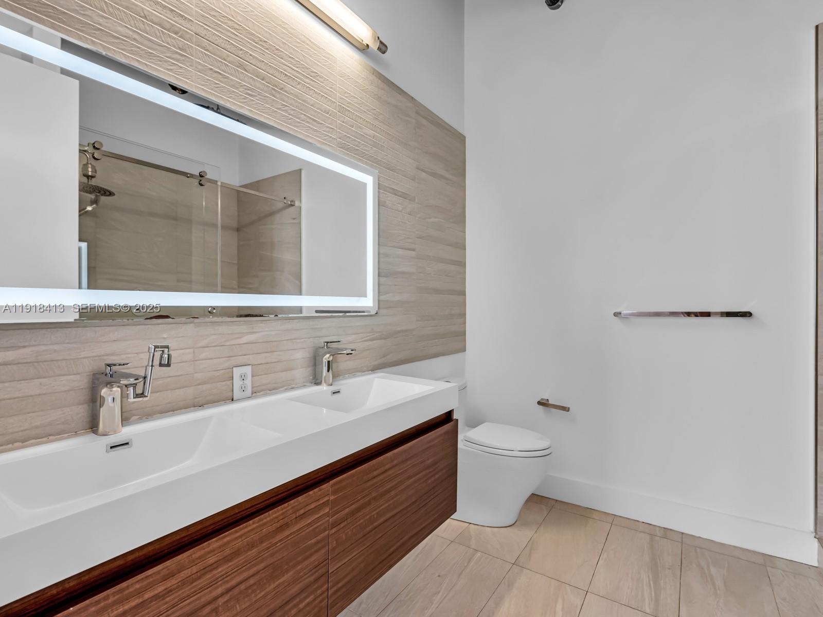 411 Northwest 1st Avenue, Unit 401 Fort Lauderdale, FL 33301 - Photo 23 of 53 a bathroom with a sink and a mirror