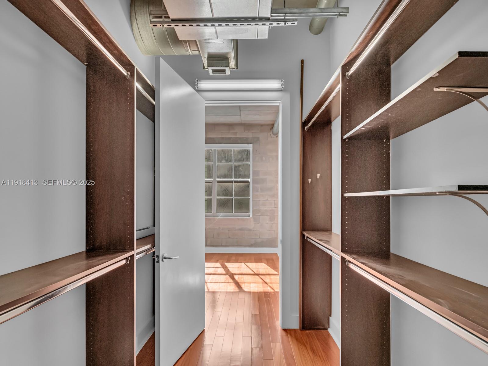 411 Northwest 1st Avenue, Unit 401 Fort Lauderdale, FL 33301 - Photo 26 of 53 a view of walk in closet with wooden floor