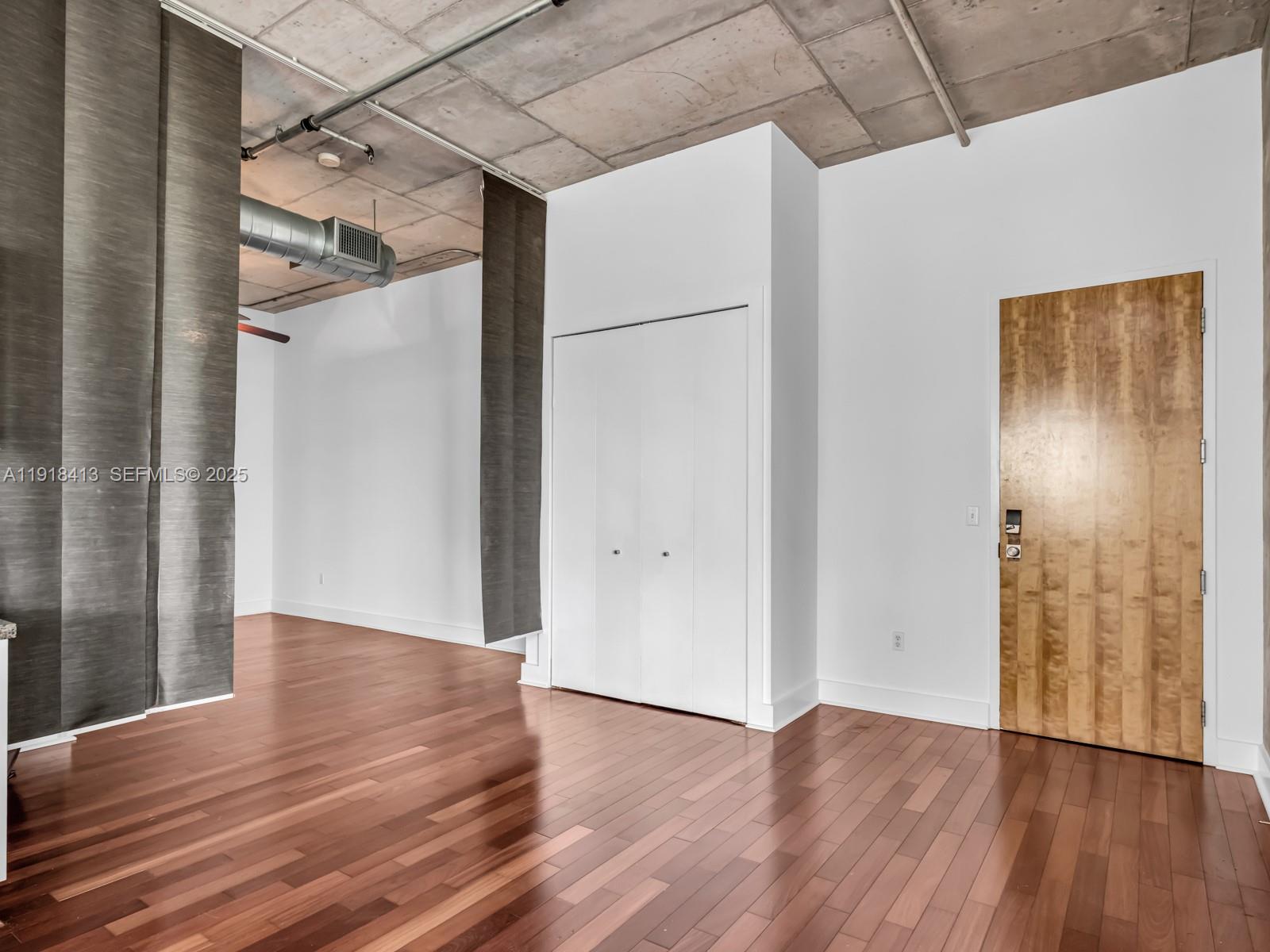 411 Northwest 1st Avenue, Unit 401 Fort Lauderdale, FL 33301 - Photo 29 of 53 a view of an empty room with wooden floor