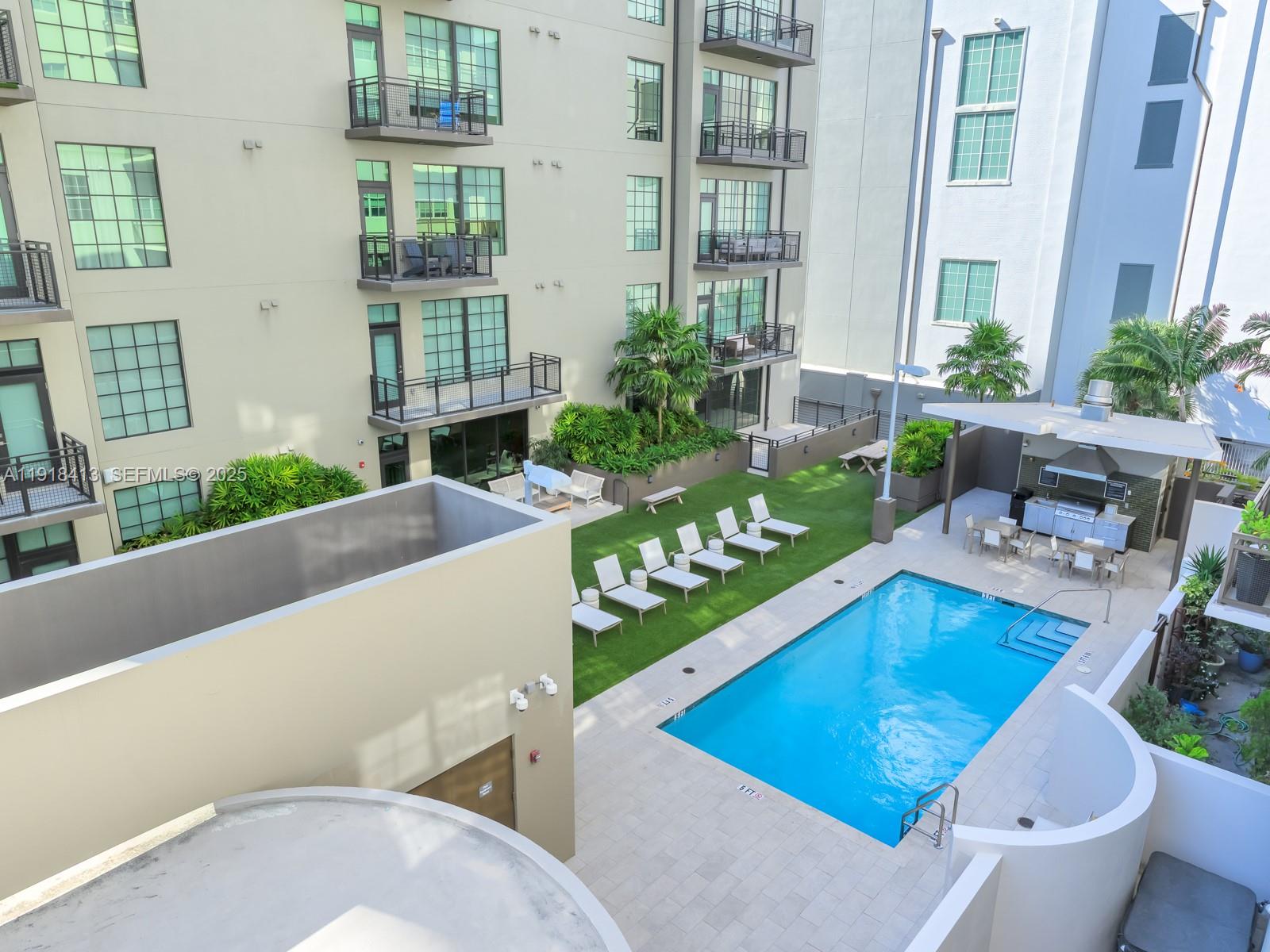 411 Northwest 1st Avenue, Unit 401 Fort Lauderdale, FL 33301 - Photo 37 of 53 a living room with patio furniture and a fireplace