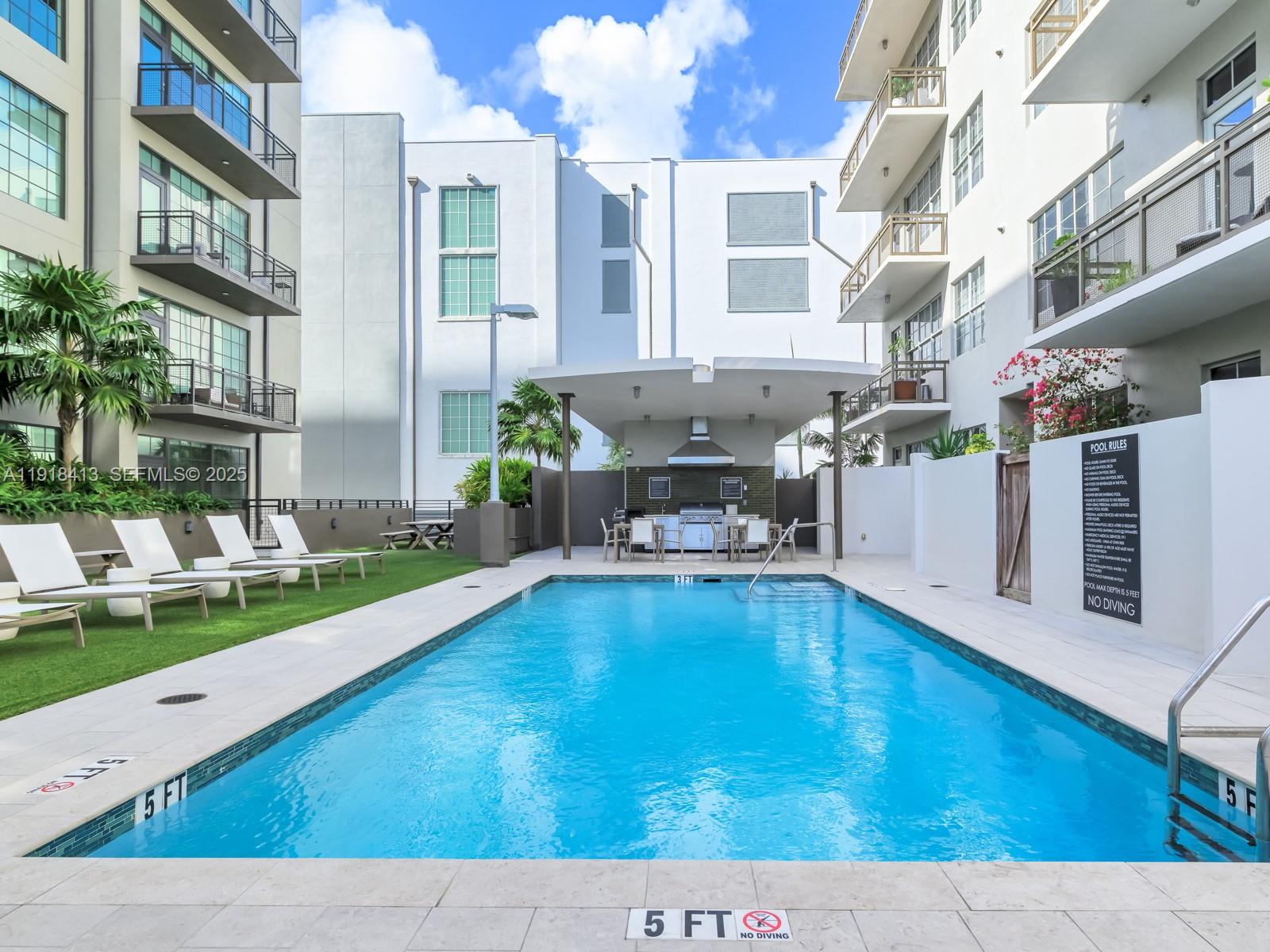 411 Northwest 1st Avenue, Unit 401 Fort Lauderdale, FL 33301 - Photo 38 of 53 a swimming pool with outdoor seating and yard