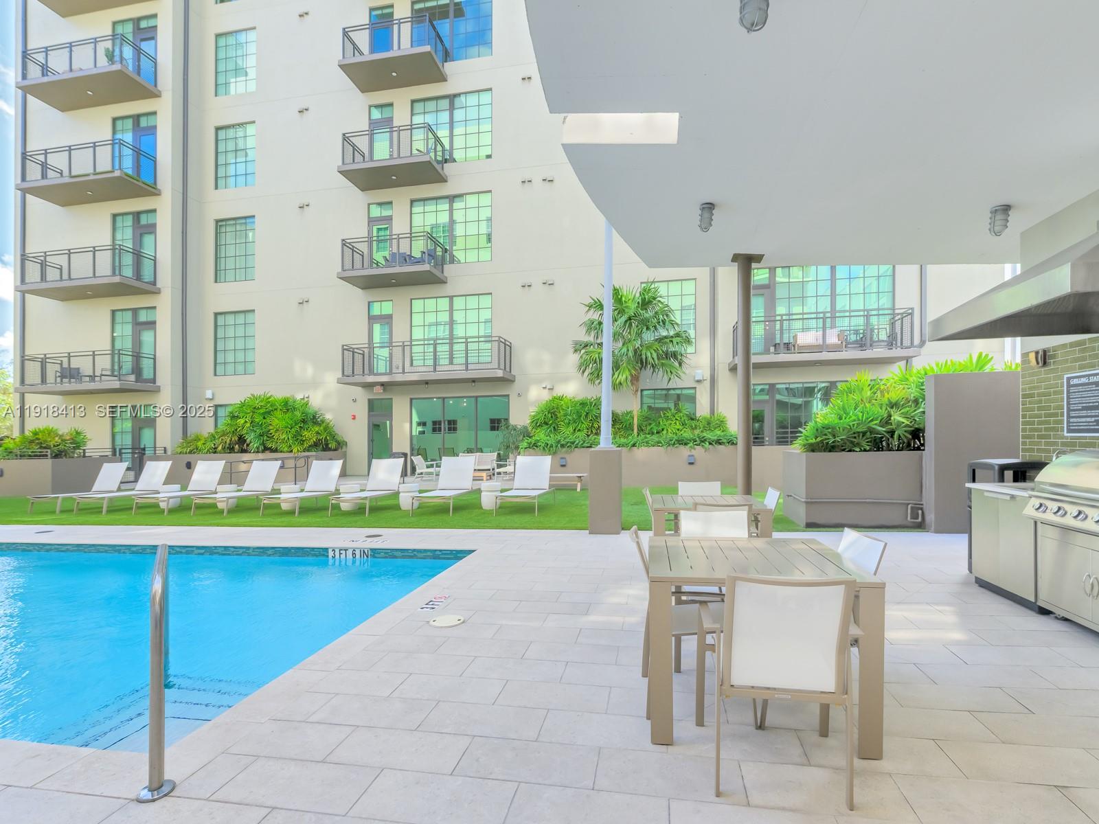 411 Northwest 1st Avenue, Unit 401 Fort Lauderdale, FL 33301 - Photo 39 of 53 a view of a dining room with a table and chairs