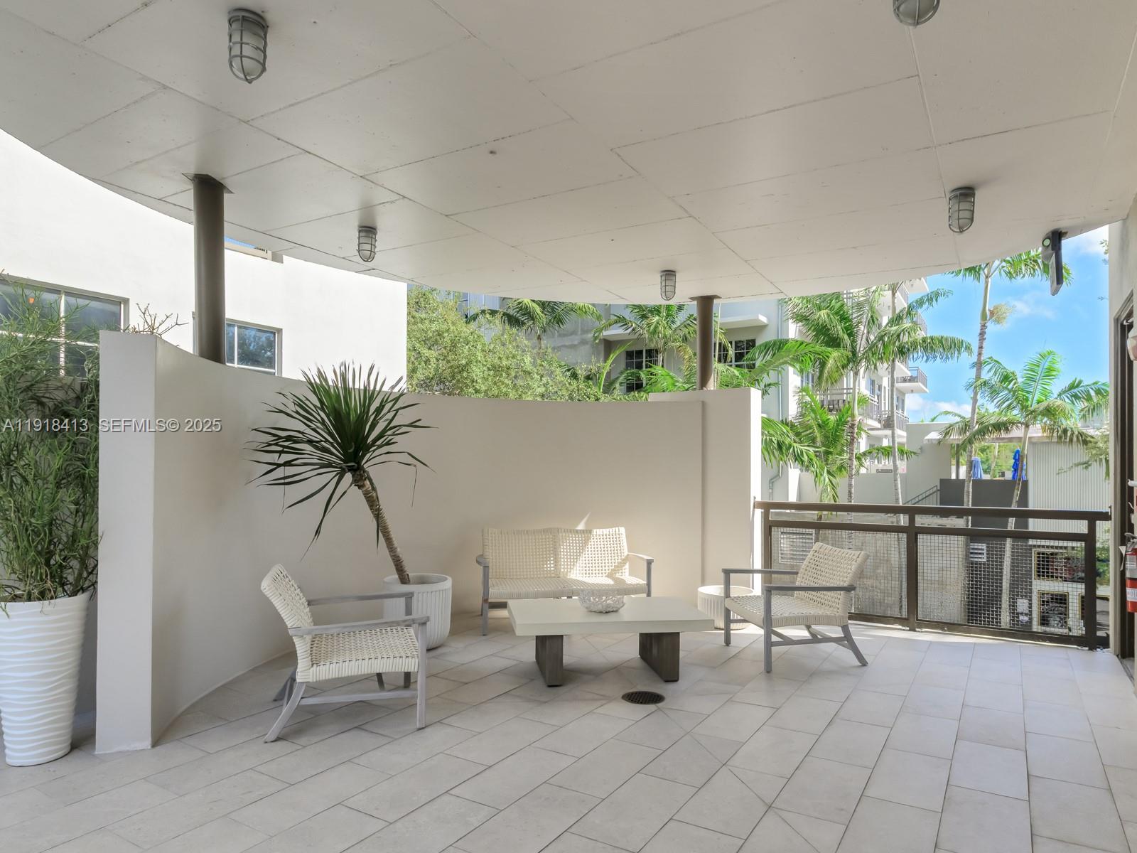 411 Northwest 1st Avenue, Unit 401 Fort Lauderdale, FL 33301 - Photo 40 of 53 a living room with patio furniture and a potted plant