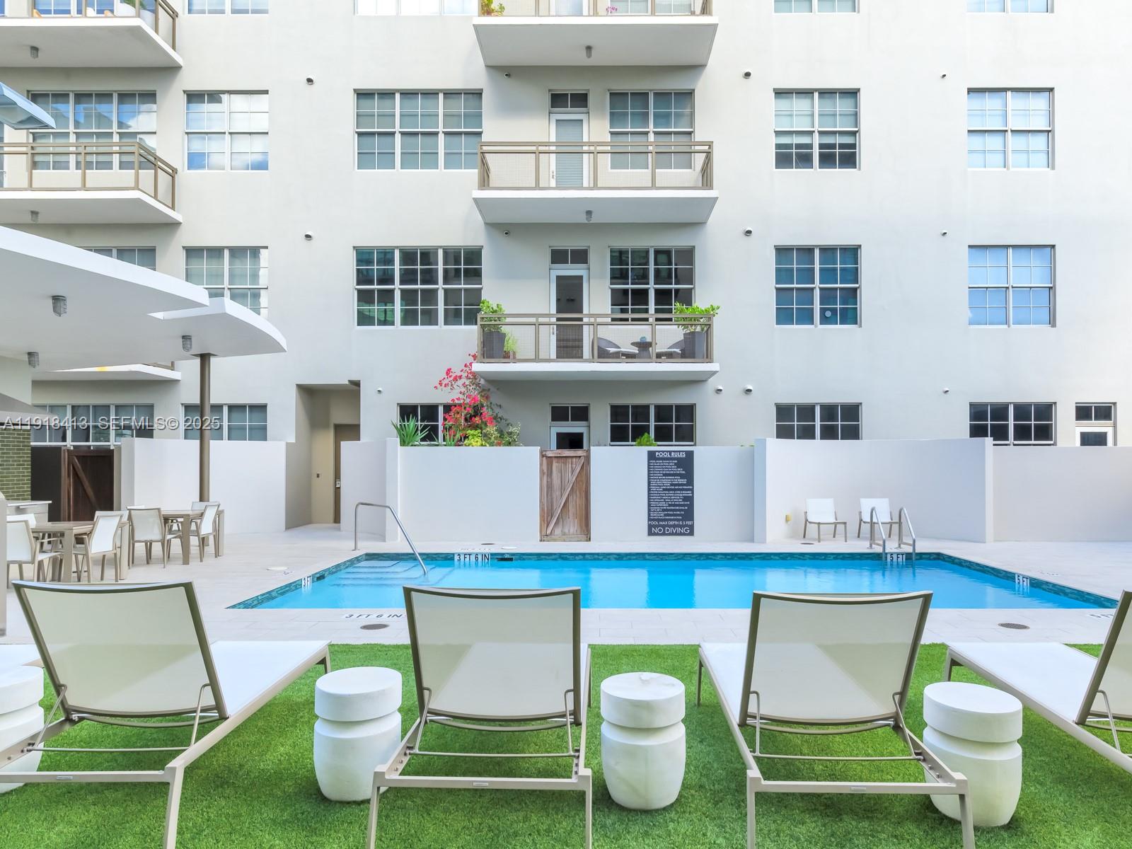 411 Northwest 1st Avenue, Unit 401 Fort Lauderdale, FL 33301 - Photo 47 of 53 a living room filled with furniture and a table