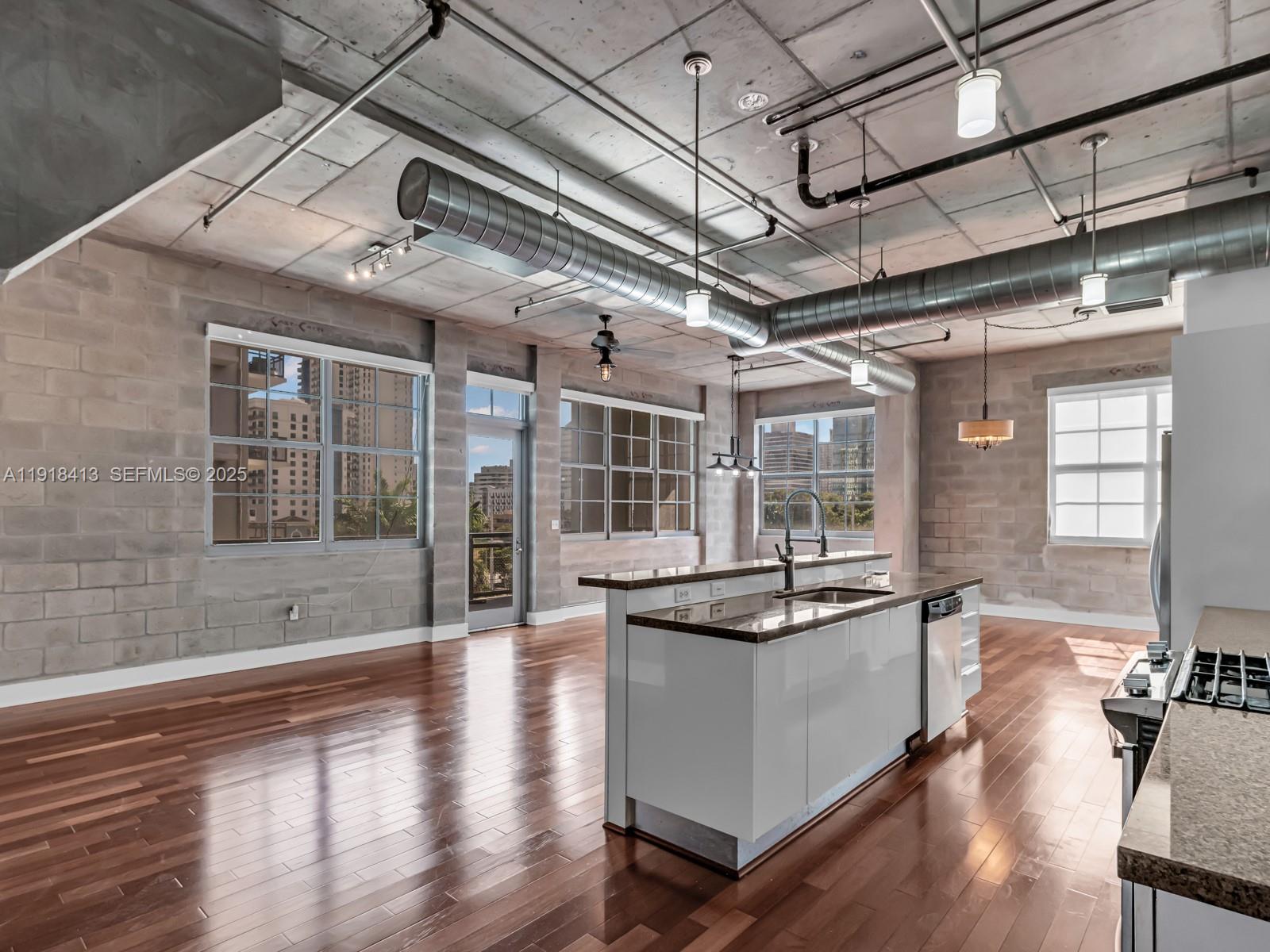 411 Northwest 1st Avenue, Unit 401 Fort Lauderdale, FL 33301 - Photo 10 of 53 a open kitchen with granite countertop a stove and cabinets