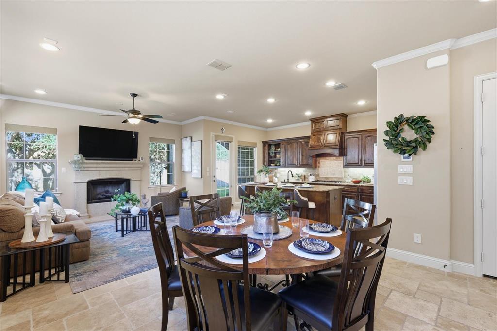 617 Two Creeks Plaza Richardson, TX 75080 - Photo 12 of 40 a view of a dining room with furniture and a fireplace