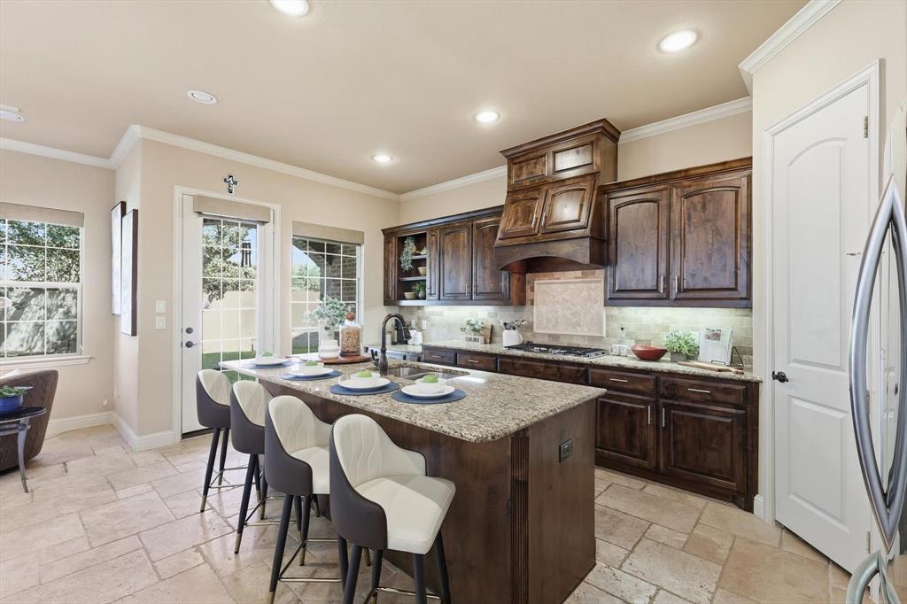 617 Two Creeks Plaza Richardson, TX 75080 - Photo 13 of 40 a kitchen with a stove a sink a refrigerator and chairs