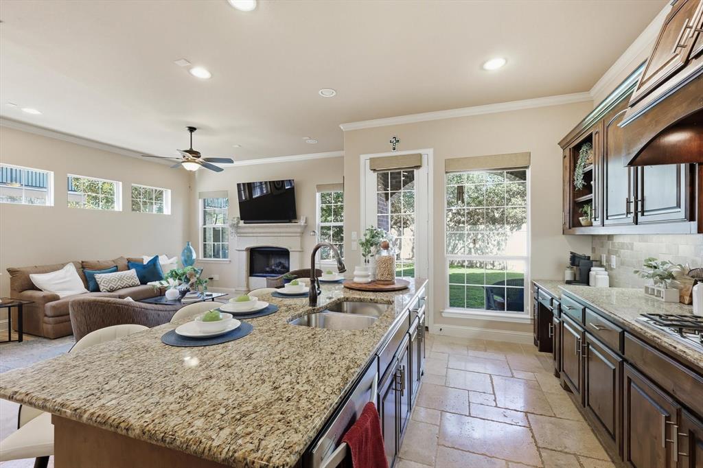 617 Two Creeks Plaza Richardson, TX 75080 - Photo 16 of 40 a kitchen with sink granite counter tops and a stove top oven